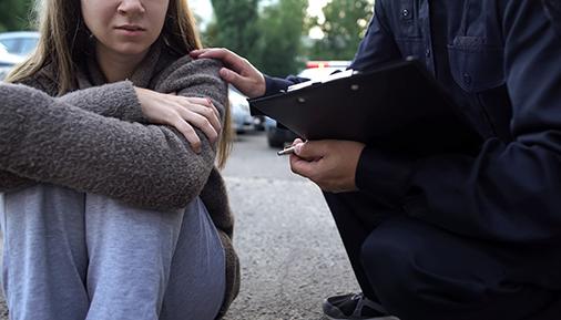 Officer trying to calm down female victim of car accident